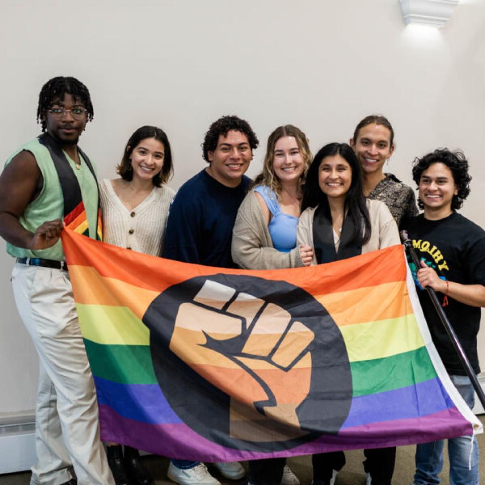 Students holding the "Pride Flag" in support of LGBTQIA+ rights.